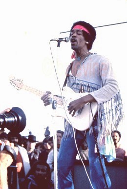 Jimi Hendrix as featured in Jimi Hendrix Live at Woodstock Alblum's 12x12 36 page Promotional book commemorating the 35Th Anniversary of Jimi's performance at the Woodstock Festival; also, as exhibited in Santa Fe, San Francisco, Rotterdam and London; as well as in Barry's private collection autograped for exhibit and sale